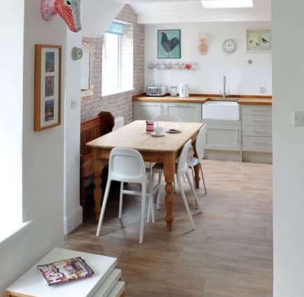 The  extension created a spacious kitchen/diner. The units are from Howdens and the wallpaper is from B&Q