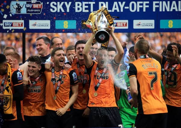 Hull City's Michael Dawson lifts the trophy after winning the Championship Play-Off Final at Wembley Stadium.