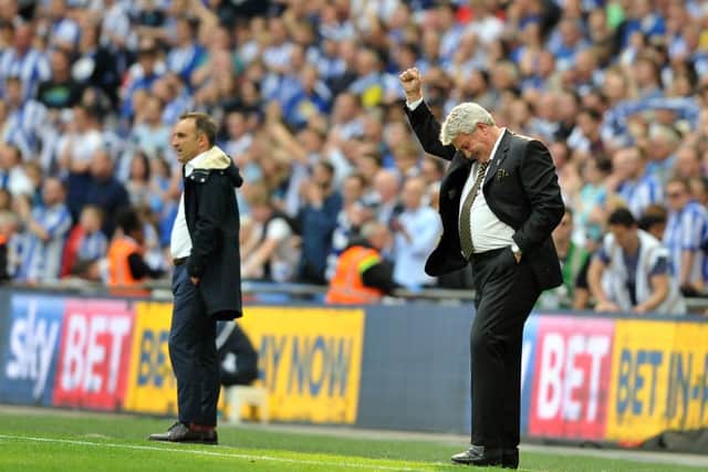 Steve Bruce celebrates his sides promotion at the final whistle as his counterpart Carlos Carvalhal looks on.  Picture Tony Johnson
