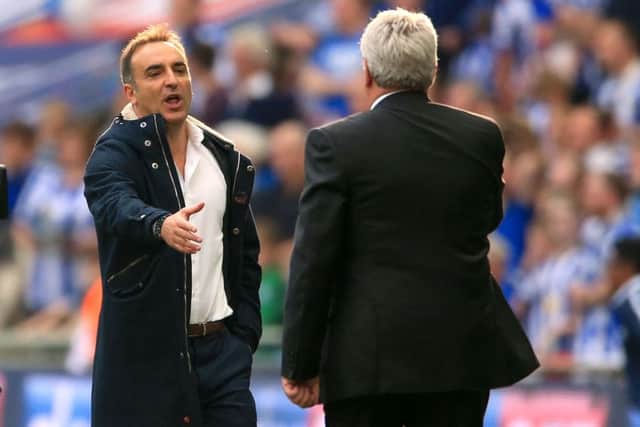 Sheffield Wednesday manager Carlos Carvalhal (left) shakes hands with Hull City manager Steve Bruce after the Championship Play-Off Final at Wembley Stadium, London.