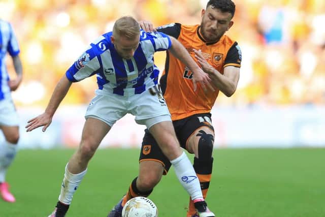 Sheffield Wednesday's Barry Bannan (left) and Hull City's Robert Snodgrass battle for the ball