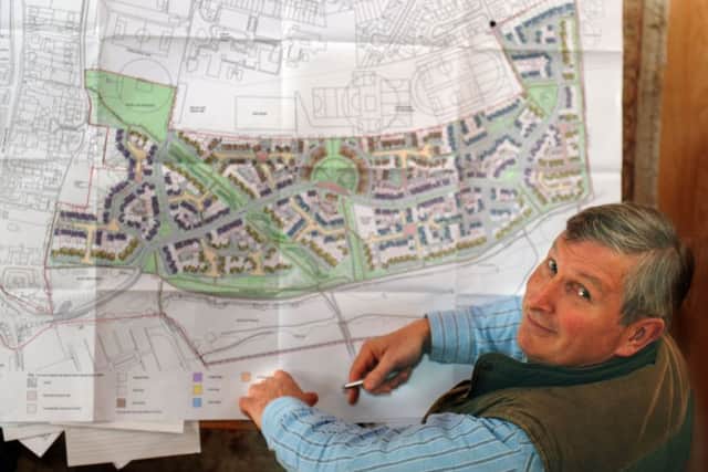 Historian Chas Jones looking at plans for  houses to be built on the northern side of the battlefield in 2013.