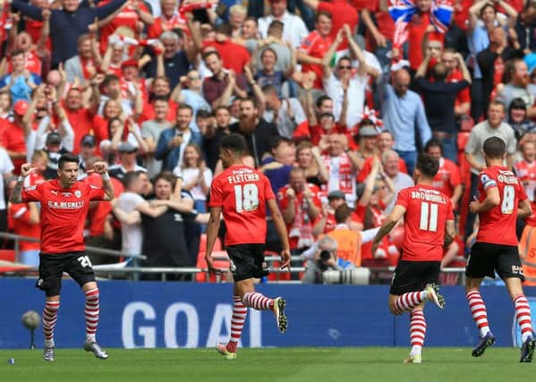 Barnsley's Adam Hammill (left) celebrates scoring his side's second goal of the match against Millwall at Wembley. Picture: Nigel French/PA.