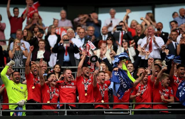 Barnsley's Conor Hourihane lifts the trophy and celebrates promotion with his team-mates after the Sky Bet League One Play-Off Final at Wembley