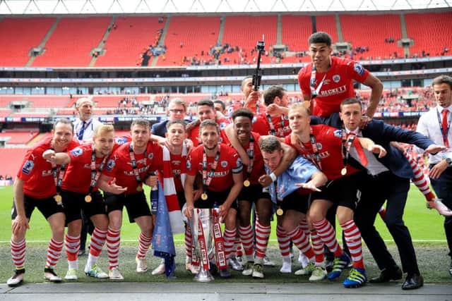 Barnsley's Conor Hourihane (centre) celebrates with the trophy and team-mates after the Sky Bet League One Play-Off Final