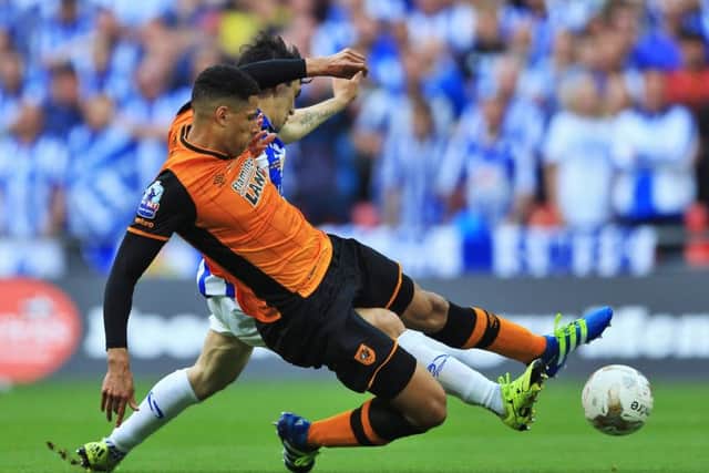 Hull City's Curtis Davies (left) and Sheffield Wednesday's Fernando Forestieri battle for the ball.