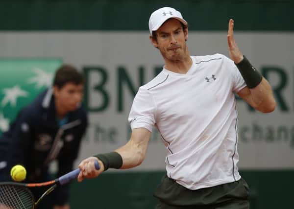 Britain's Andy Murray returns the ball to John Isner during their fourth round match Picture: AP/Michel Euler)