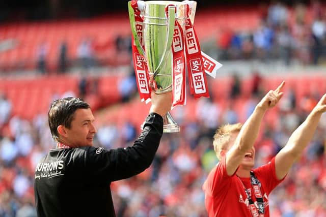 Barnsley caretaker manager Paul Heckingbottom celebrates with the League One play-off trophy. Picture: Nigel French/PA.
