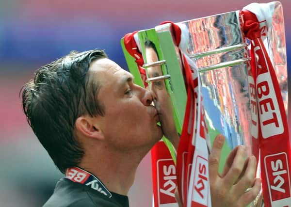 Barnsley manager Paul Heckingbottom with the trophy after guiding his side to promotion.  Picture: Tony Johnson
