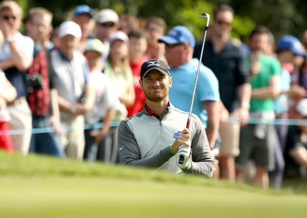 Chris Wood plays out of a bunker on the 16th hole on his way to winning the BMW PGA Championship at Wentworth. Picture: Steve Paston/PA.