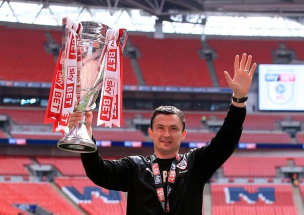 Barnsley caretaker manager Paul Heckingbottom celebrates with the trophy after the League One Play-Off final at Wembley (Picture: Nick Potts/PA Wire).