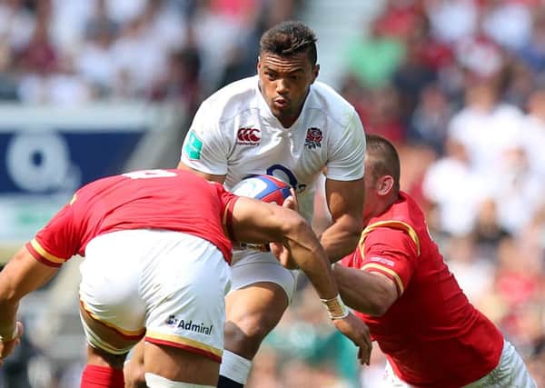 England's Luther Burrell (centre) looks to break through the Welsh line at Twickenham. Picture: PA.
