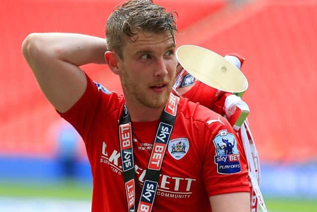 GOING UP: Barnsley strikers Sam Winnall with the trophy after the League One play-off final victory at Wembley. Picture: PA