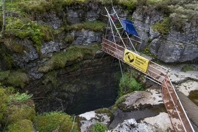 Date:27th May 2016. Picture James Hardisty.
Gaping Gill, situated on the SW slopes of Ingleborough at an altitude of 1300ft (400m) above sea level in the heart of the Yorkshire Dales. A natural cave in North Yorkshire and probably the most well known pothole in the United Kingdom. Twice a year between May and August two local caving clubs Bradford Pothole and Craven Pothole arrange the Gaping Gill Winch. This is where cavers can explorer well known tunnels and visitors to the site are lowered in a chair decending 330ft(100m) through BritainÃ¢Â¬"s highest unbroken waterfall as it lands on the floor of Gaping Gill, the largest cavern in Britain, known as the Main Chamber and large enough to fit most of York Minster, two Boeing 747 Jumbo Jets, the volume of 18 Olympic swimming pools or the plan area of ten doubles tennis courts.