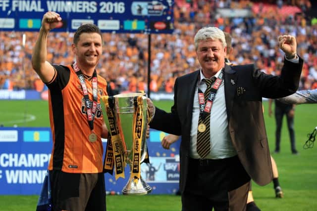 Hull City's Alex Bruce and dad/manager Steve celebrate after winning the Championship Play-Off Final at Wembley. Picture: Nick Potts/PA.