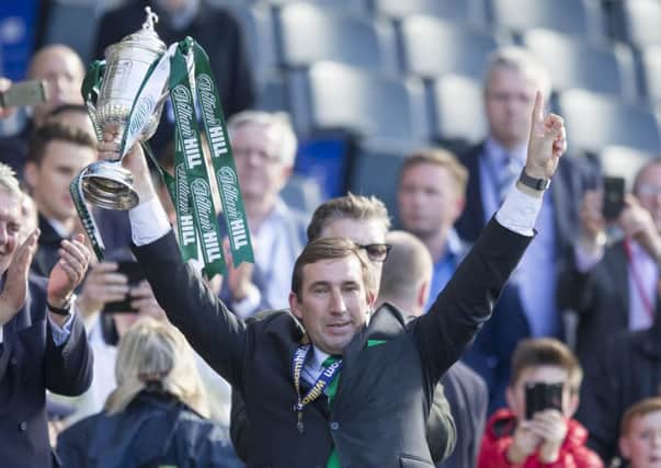 Hibernian manager Alan Stubbs lifts the William Hill Scottish Cup earlier this month. Picture: PA.