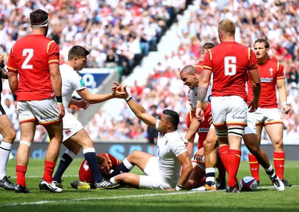 England's Luther Burrell, centre, celebrates scoring a try against Wales at Twickenham on Sunday (Picture: Gareth Fuller/PA).