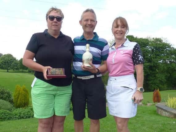 Buckwell Trophy winners Carole Hampson, left, and Mike Greenberry with lady captain Gwyn Greenberry, who presented the trophy.