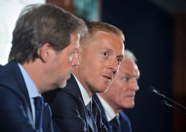 Garry Monk, unveiled as Leeds Uniteds new head coach at Elland Road, is flanked by club legend Eddie Gray and new director Niccolo Barratieri (Picture: Tony Johnson).