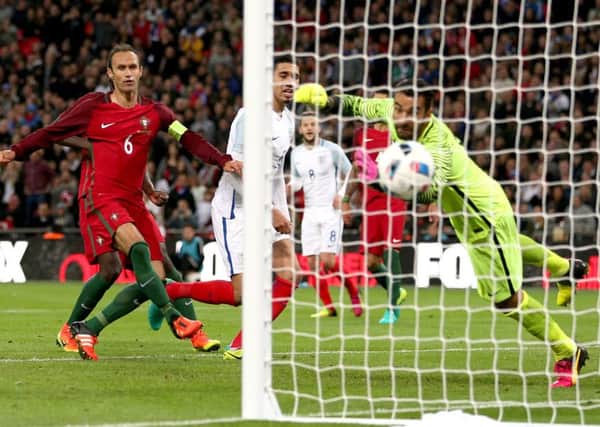 England's Chris Smalling, obscured by post, scores England's winner in the friendly with Portugal (Picture: David Davies/PA Wire).