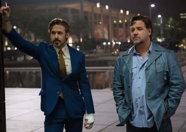 Ryan Gosling as Holland March and Russell Crowe as Jackson Healy in Nice Guys. .