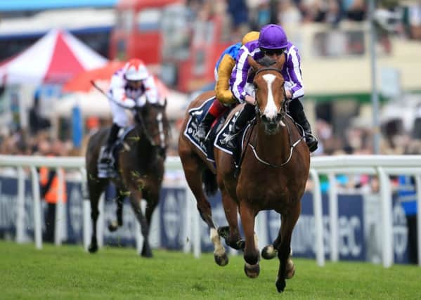 Minding ridden by Ryan Moore on the way to winning The Investec Oaks.
