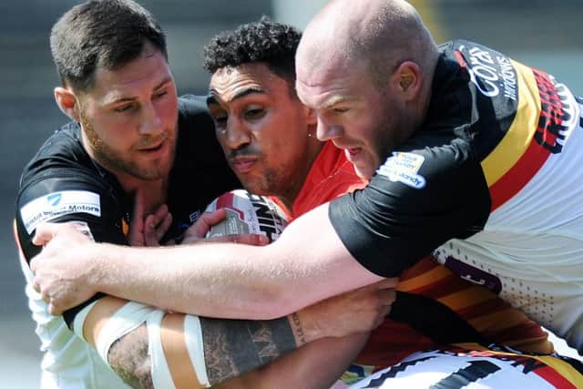 Dewsbury's Dalton Grant is wrapped up by Bradford's defence.