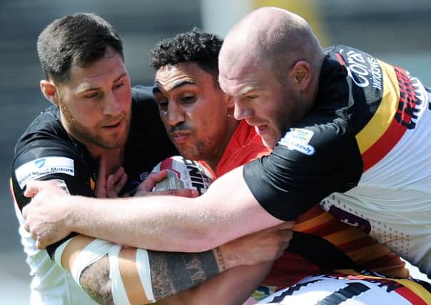 Dewsbury's Dalton Grant is wrapped up by Bradford's defence.