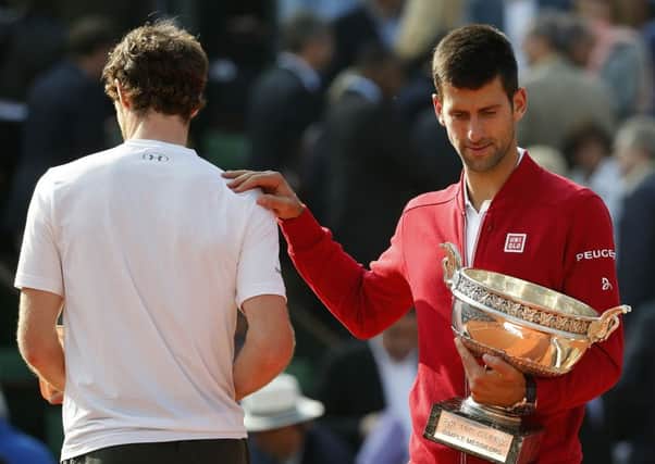 Serbia's Novak Djokovic, right, puts his hand on Britain's Andy Murray's shoulder.