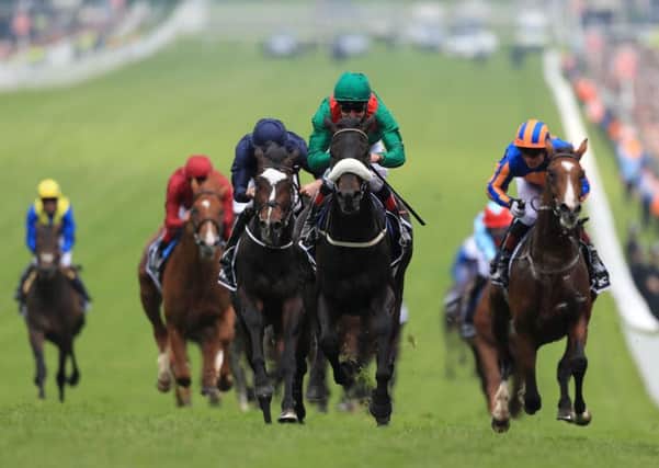 Harzand, centre, ridden by jockey Pat Smullen, wins the Investec Derby (Picture: David Davies/PA Wire).
