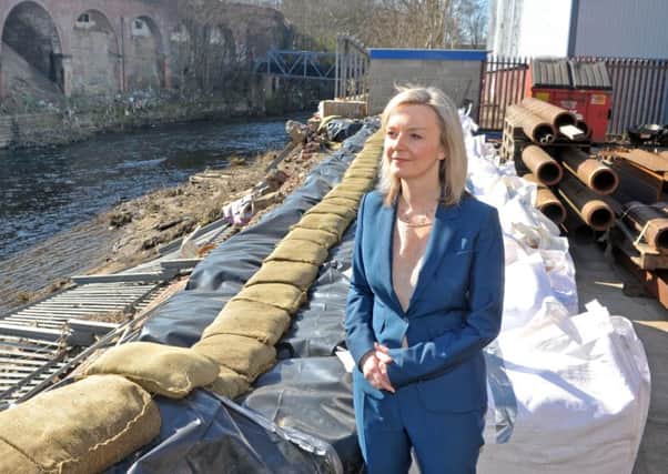 Environment Secretary Elizabeth Truss inspects flood damage in Kirkstall, Leeds.