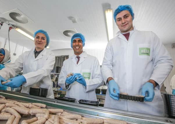 Heck Sausages. Ellie Keeble, 20 and Ben Stones, 22, give a tour of the Heck sausage factory to Richmond MP, Rishi Sunak.