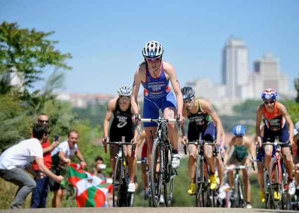 Britain's Non Stanford gets out of the saddle on the tough hills in Madrid to win her first World Triathlon Series title, in Madrid, Spain.  (AP Photo/ITU, Janos Schmidt)