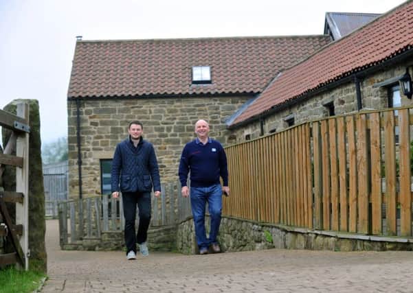 Alex (left) and Chris Yates walking by some of the holiday cottages on Hill Farm, Beck Hole. (GL1010/25b)