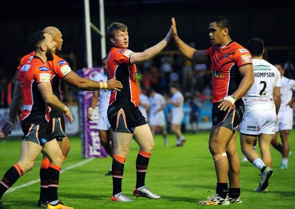 Tigers' Paddy Flynn, centre, celebrates one of his hat-trick of tries.