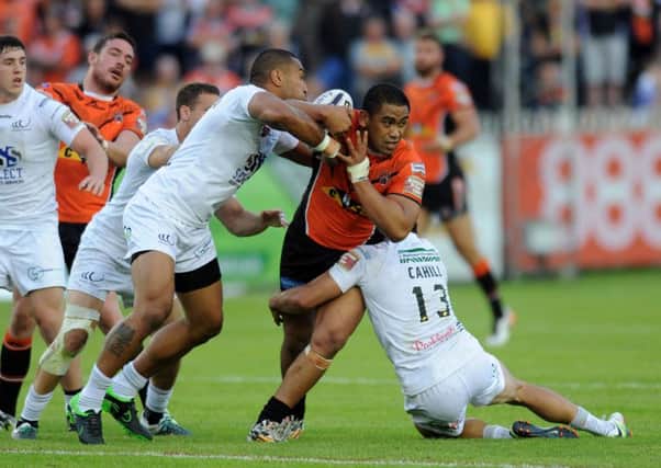 BAD NIGHT: Castleford Tigers' Junior Moors is tackled by Widnes's Hep Cahill and Patrick Ah Van at The Jungle on Thursday night. 
Picture: Jonathan Gawthorpe