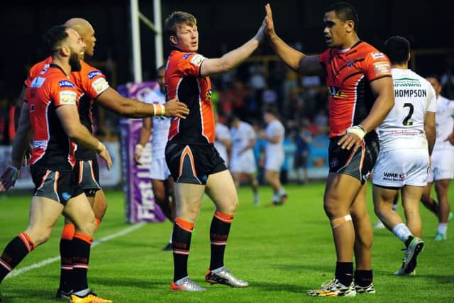 Castleford Tigers' Paddy Flynn, centre, celebrates his second try in Thursday's defeat to Widnes. Picture: Jonathan Gawthorpe