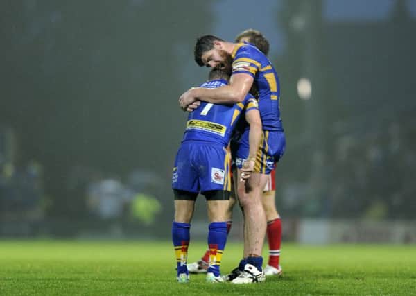 Leeds duo Rob Burrow and Keith Galloway embrace at the final hooter. Picture Bruce Rollinson