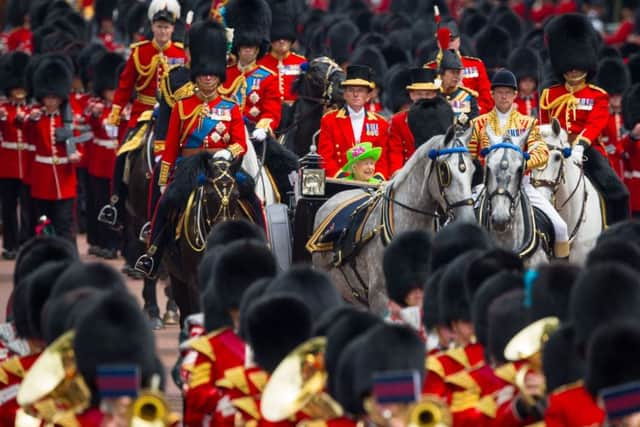 Queen Elizabeth II returns to Buckingham Palace in central London following the Trooping the Colour ceremony at Horse Guards Parade as the Queen celebrates her official birthday today