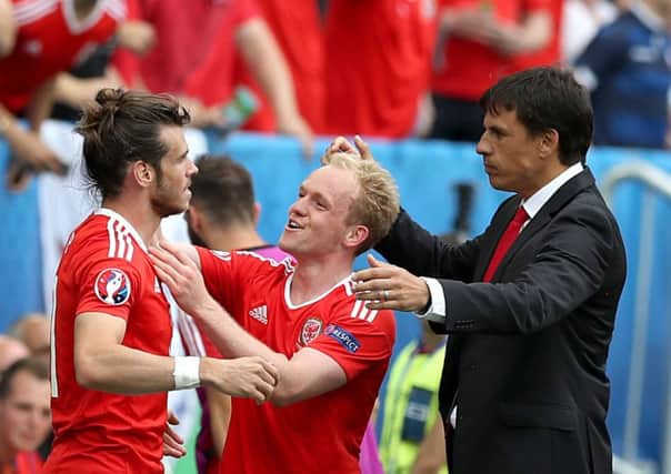 Wales' Gareth Bale (left) celebrates scoring their first goal of the game with team-mate Jonathan Williams and manager Chris Coleman (right). (Picture: PA)