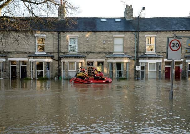 Members of a Mountain Rescue team paddle along Huntington Road in York during the floods.   Photo: Anna Gowthorpe/PA Wire