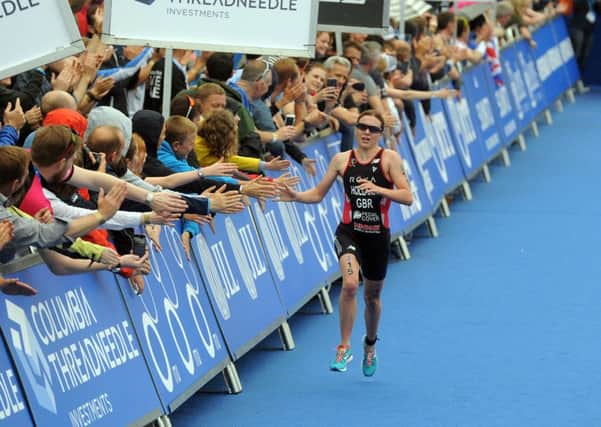 Vicky Holland is greeted by a huge crowd  in Leeds' Millenium Square as she runs into third place in the 2016 ITU World Triathlon.  Picture: Tony Johnson.