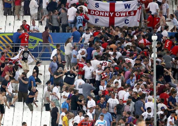 Spectators try to escape from the stands as clashes break out at the end of the Euro 2016 Group B match between England and Russia, at the Velodrome stadium in Marseille. (PA).