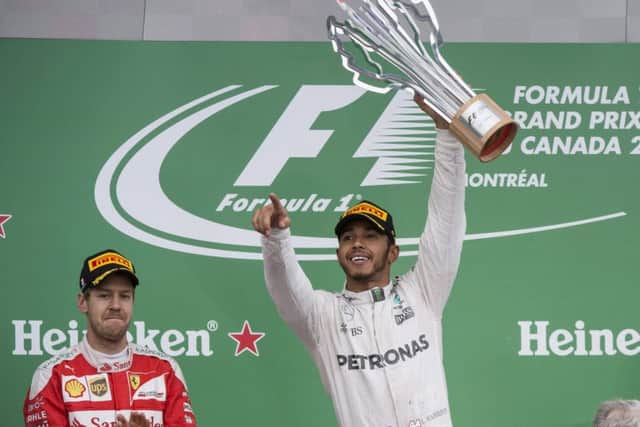 Mercedes driver Lewis Hamilton, right, of Britain, celebrates his victory at Montreal.