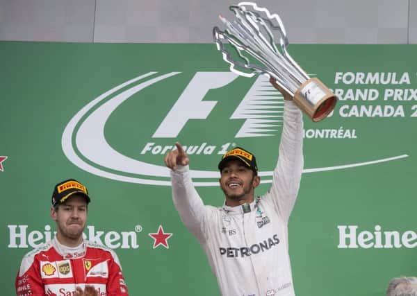 Mercedes driver Lewis Hamilton, right, of Britain, celebrates his victory at Montreal.