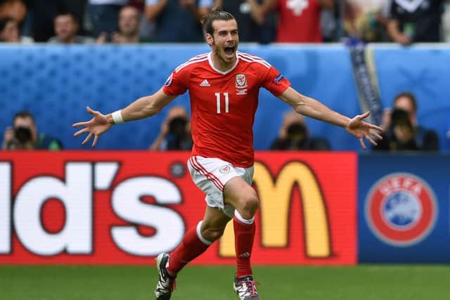 Wales' Gareth Bale celebrates scoring this free-kick against Slovakia in their Group B match.