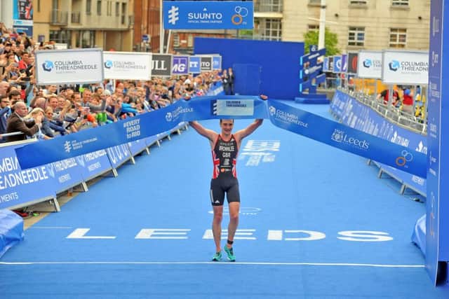 Alistair Brownlee crosses the line to win the gold medal in the elite men's race, which was held after the amateur race. Pic: Tony Johnson.