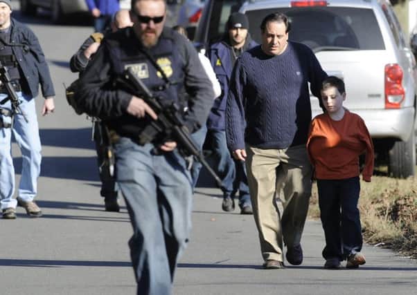Parents are reunited with their children following the Sandy Hook shooting in 2012. (PA).