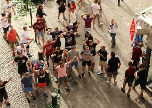 Russian fans chant in the Old Port Square in Marseille. A hardcore of 150 have been blamed for initiating attacks on England fans. Niall Carson/PA Wire