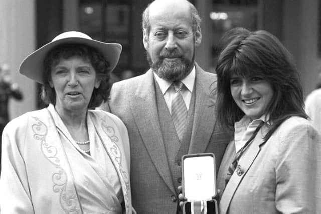 Sir Clement Freud with his wife Jill (left) and daughter Emma after receiving his knighthood at Buckingham Palace in 1987